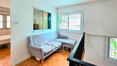 Bright and cozy corner with modern sofa and large windows in a stylish home.