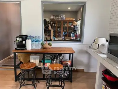 Charming kitchen with modern appliances and cozy seating area, perfect for culinary enthusiasts.