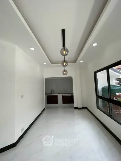 Modern minimalist interior with sleek lighting and large window, perfect for stylish living.