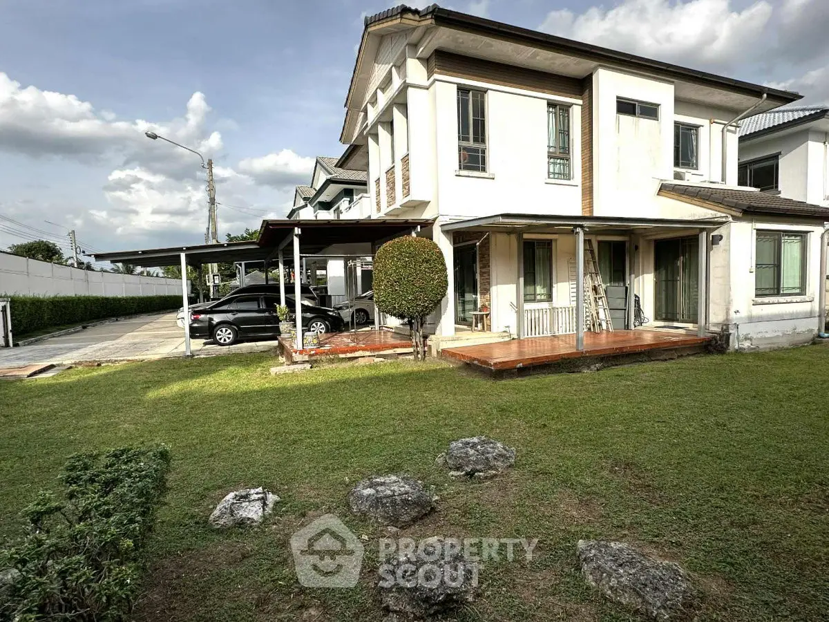 Charming two-story house with spacious garden and carport in a serene neighborhood.