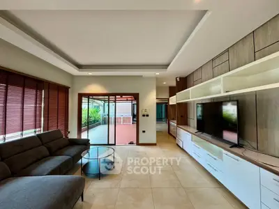 Spacious living room with modern decor and large sliding doors to balcony