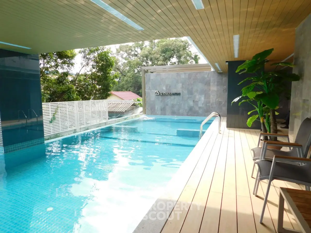 Luxurious rooftop pool with modern design and lush greenery, perfect for relaxation and leisure.