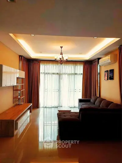 Spacious living room with elegant lighting and modern furniture, perfect for relaxation and entertainment.