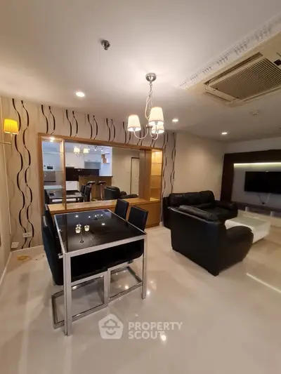 Modern living room with stylish dining area and cozy seating, featuring elegant lighting and contemporary decor.