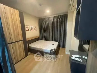 Modern bedroom with stylish decor and ample storage in a cozy apartment.