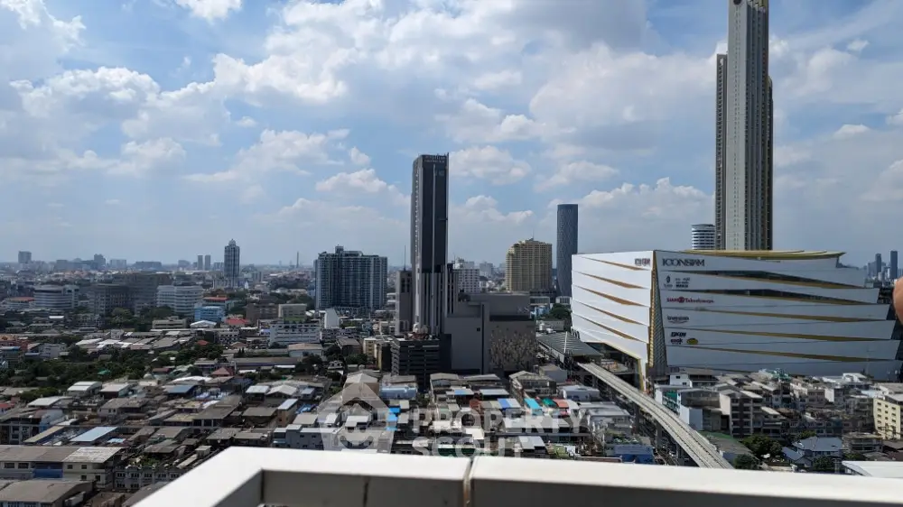 Stunning cityscape view from high-rise balcony with modern skyscrapers and blue sky