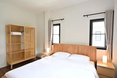 Spacious bedroom with wooden furniture and natural light