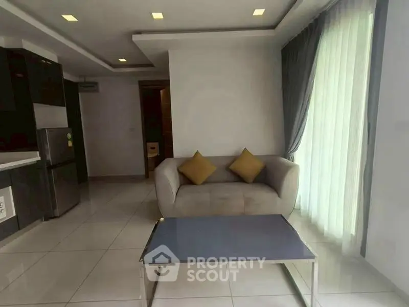 Modern living room with sleek sofa and natural light in a stylish apartment.