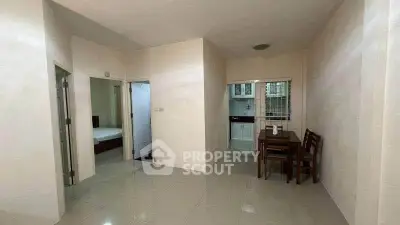 Spacious apartment interior with dining area and kitchen view