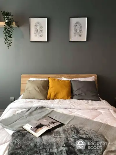 Cozy bedroom with stylish decor and modern artwork