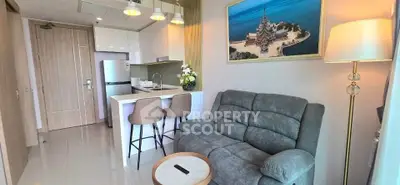 Modern living room with cozy sofa and stylish kitchen in open layout apartment.