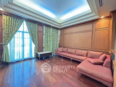 Spacious living room with elegant wood paneling and large windows