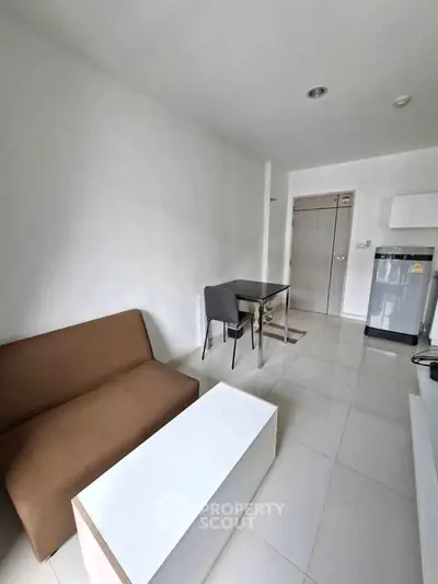 Modern minimalist living room with sleek furniture and compact design, perfect for urban living.