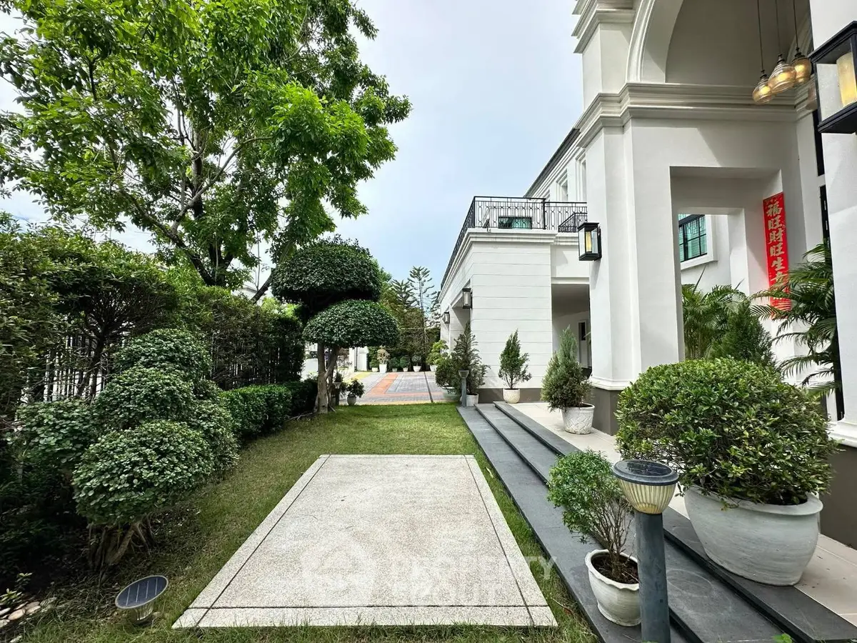 Elegant exterior view of luxury home with manicured garden and stylish entrance