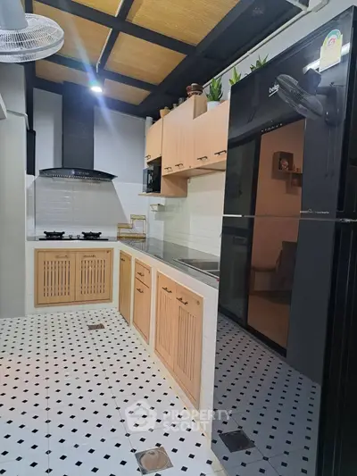 Modern kitchen with sleek black appliances and stylish wooden cabinets