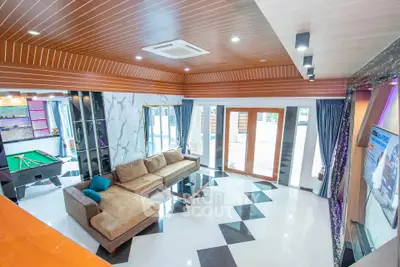 Luxurious living room with modern design and pool table, perfect for entertainment.