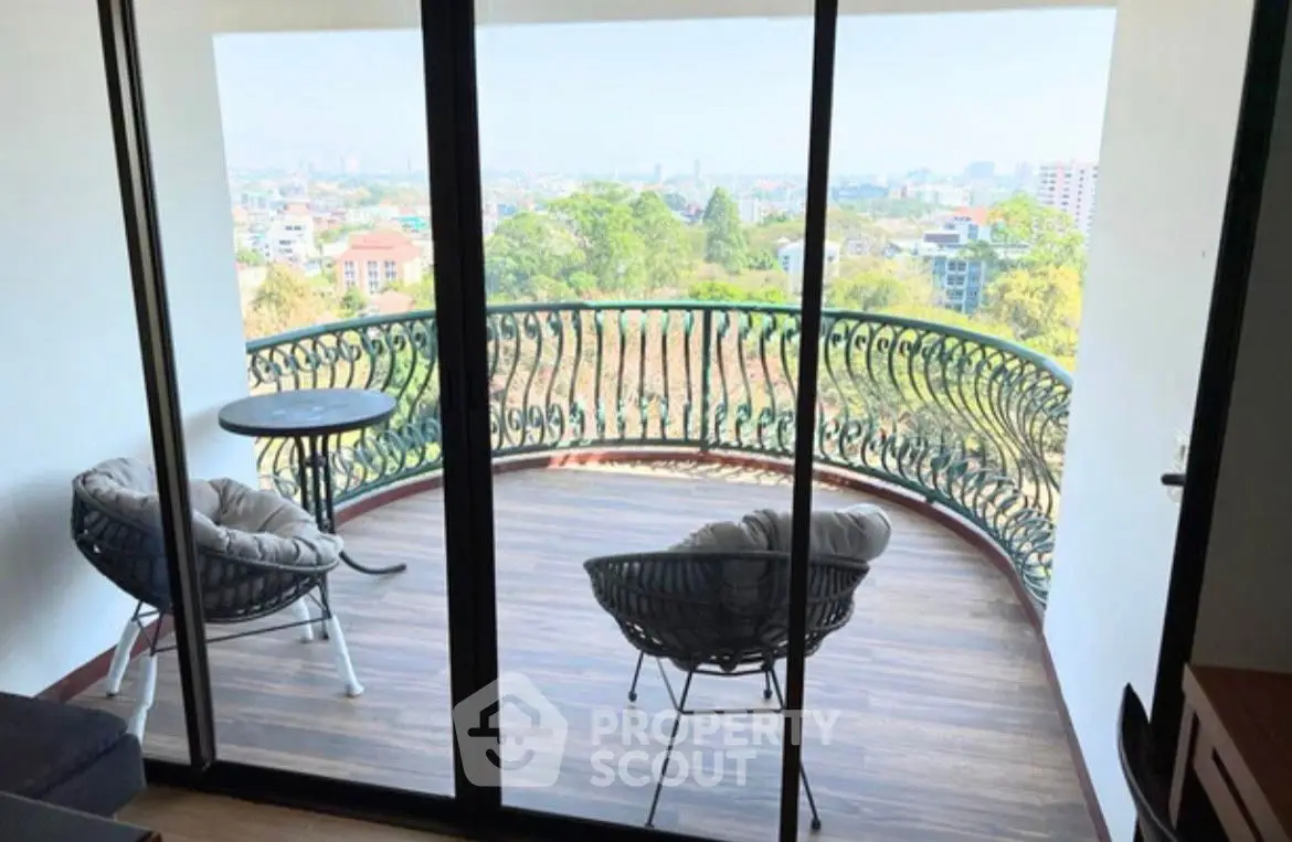 Stunning balcony with panoramic city view and cozy seating area