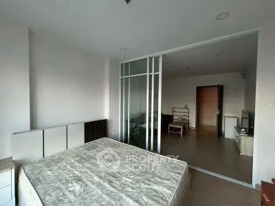 Spacious bedroom with sliding glass doors and modern furnishings