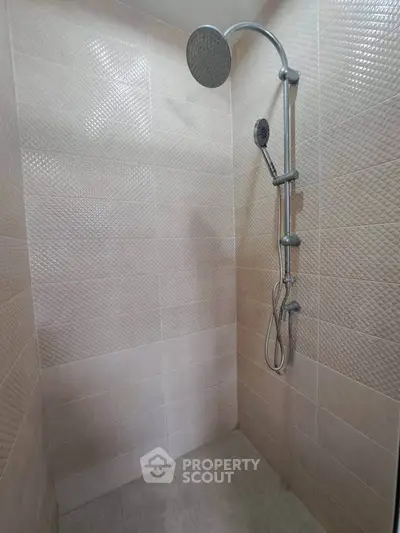 Modern bathroom shower with sleek tile design and rainfall showerhead.