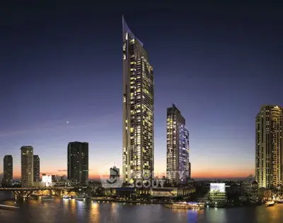 Stunning skyline view of modern high-rise buildings at sunset by the river.