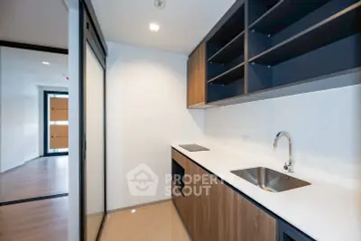 Modern kitchen with sleek cabinetry and built-in appliances in a contemporary apartment.