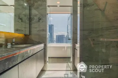 Luxurious modern bathroom with stunning city view and elegant marble finishes.