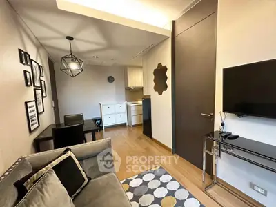 Modern living room with stylish decor and open kitchen layout, featuring elegant furniture and contemporary lighting.