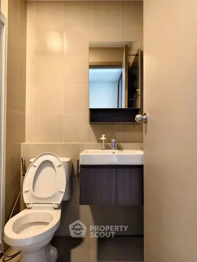 Modern bathroom with sleek fixtures and neutral tiles