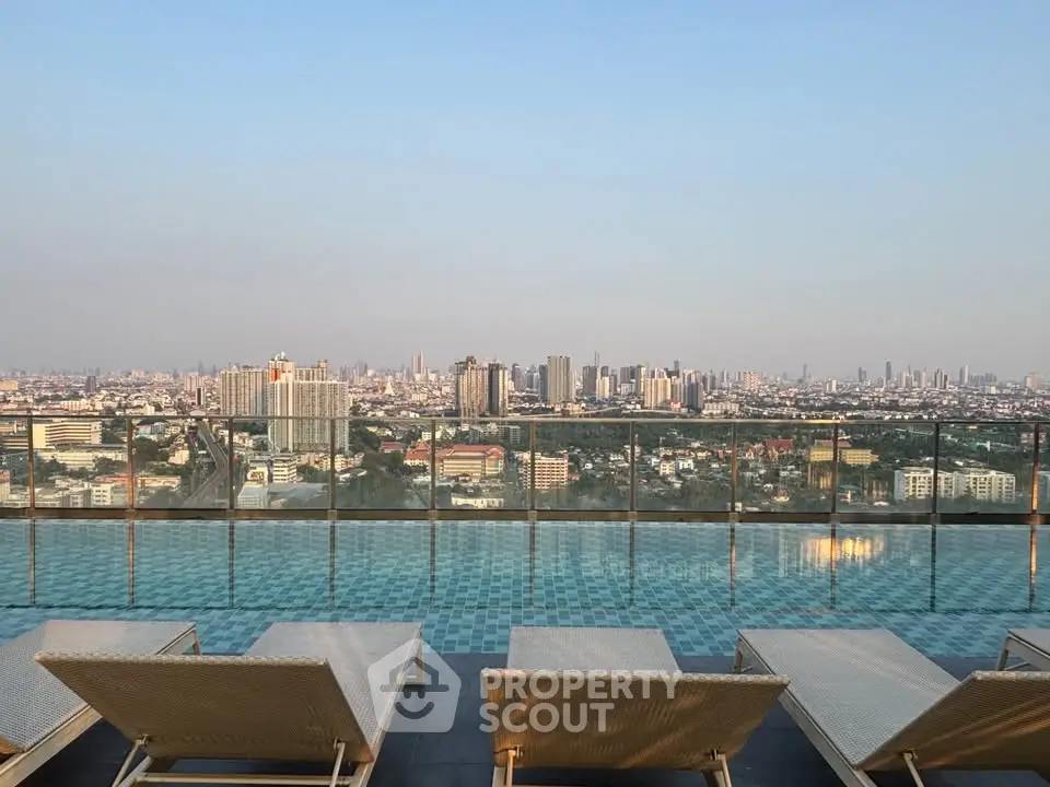 Stunning rooftop pool with panoramic city skyline views, perfect for luxury urban living.