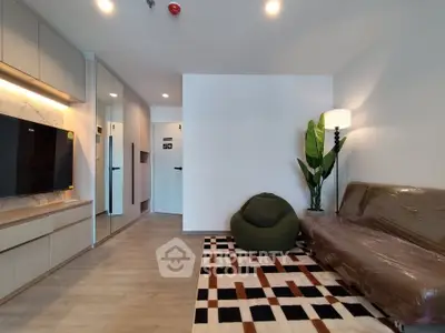 Modern living room with stylish decor, featuring a cozy sofa, bean bag, and sleek TV unit.