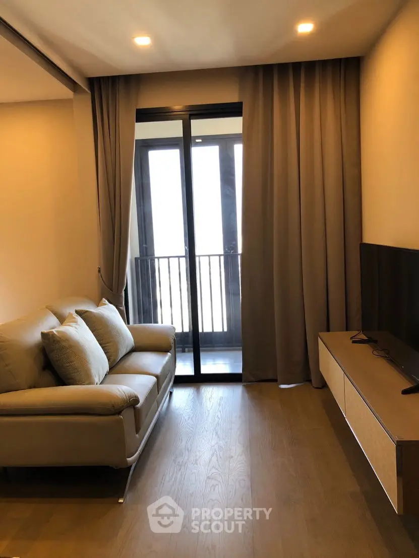Modern living room with cozy sofa and large window balcony view