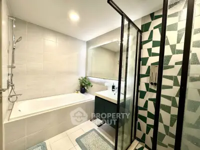 Modern bathroom with bathtub and stylish geometric shower design
