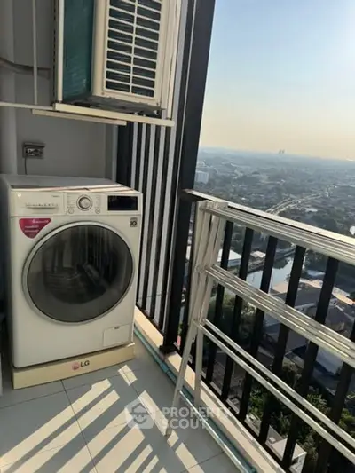 High-rise balcony with washing machine and stunning city view, perfect for urban living.