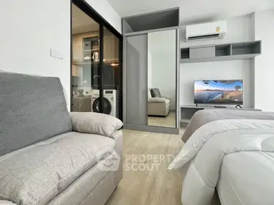 Modern bedroom with cozy seating and sleek storage solutions