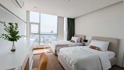 Spacious bedroom with twin beds and stunning city view, perfect for urban living.