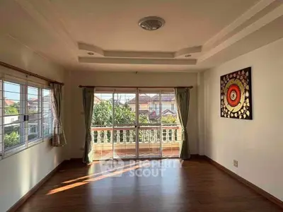 Spacious living room with large windows and balcony view