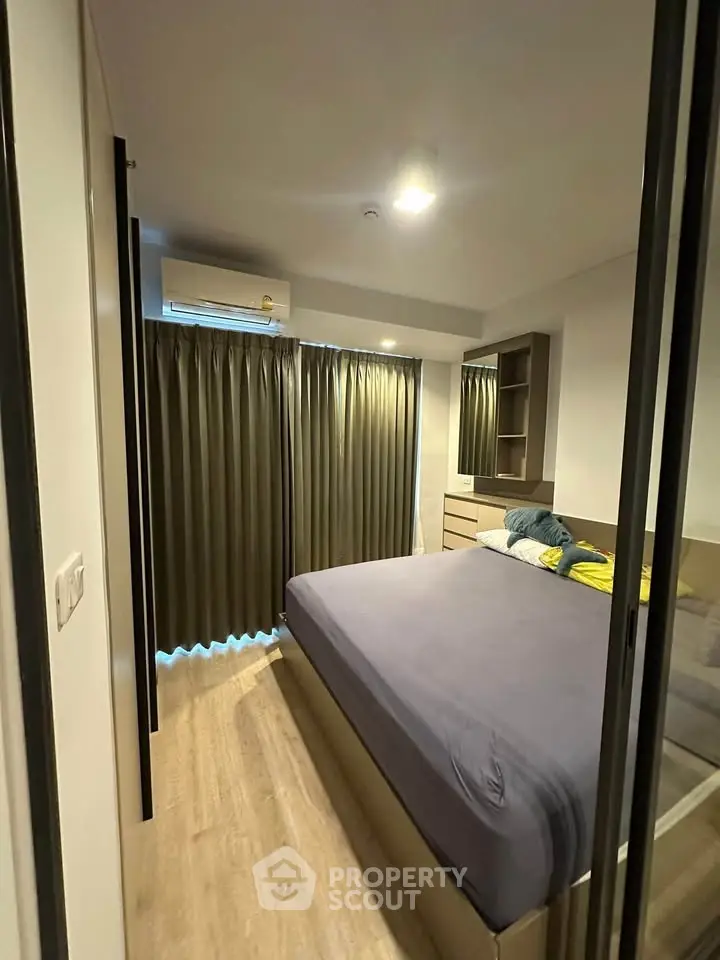 Modern bedroom with sleek design and ample natural light, featuring a comfortable bed and stylish decor.