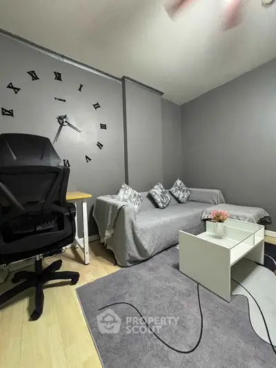 Modern living room with stylish decor and comfortable seating, perfect for relaxation and productivity.