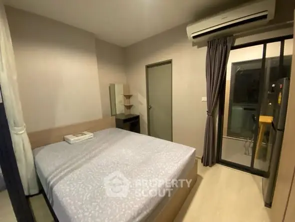 Cozy bedroom with modern air conditioning and balcony access