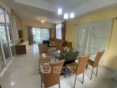 Spacious living and dining area with modern furniture and large windows