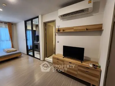 Modern studio apartment with sleek wooden furniture and air conditioning, perfect for urban living.