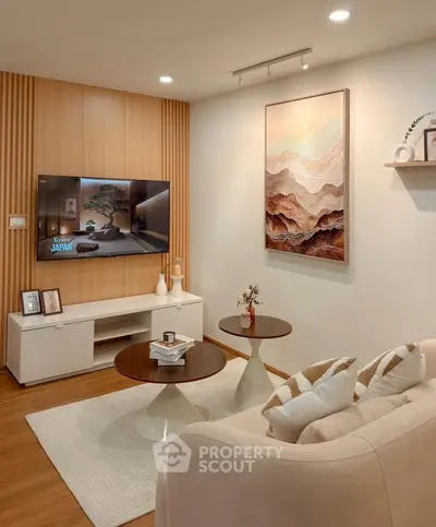 Modern living room with stylish decor, wall-mounted TV, and elegant furniture.