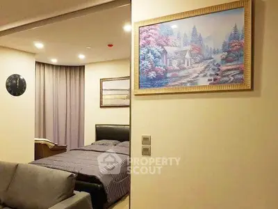 Cozy bedroom with elegant decor and framed artwork, featuring a comfortable bed and soft lighting.