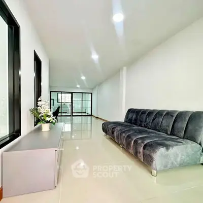 Modern living room with sleek sofa and bright natural lighting