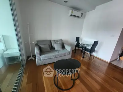 Modern living room with sleek furniture and wooden flooring