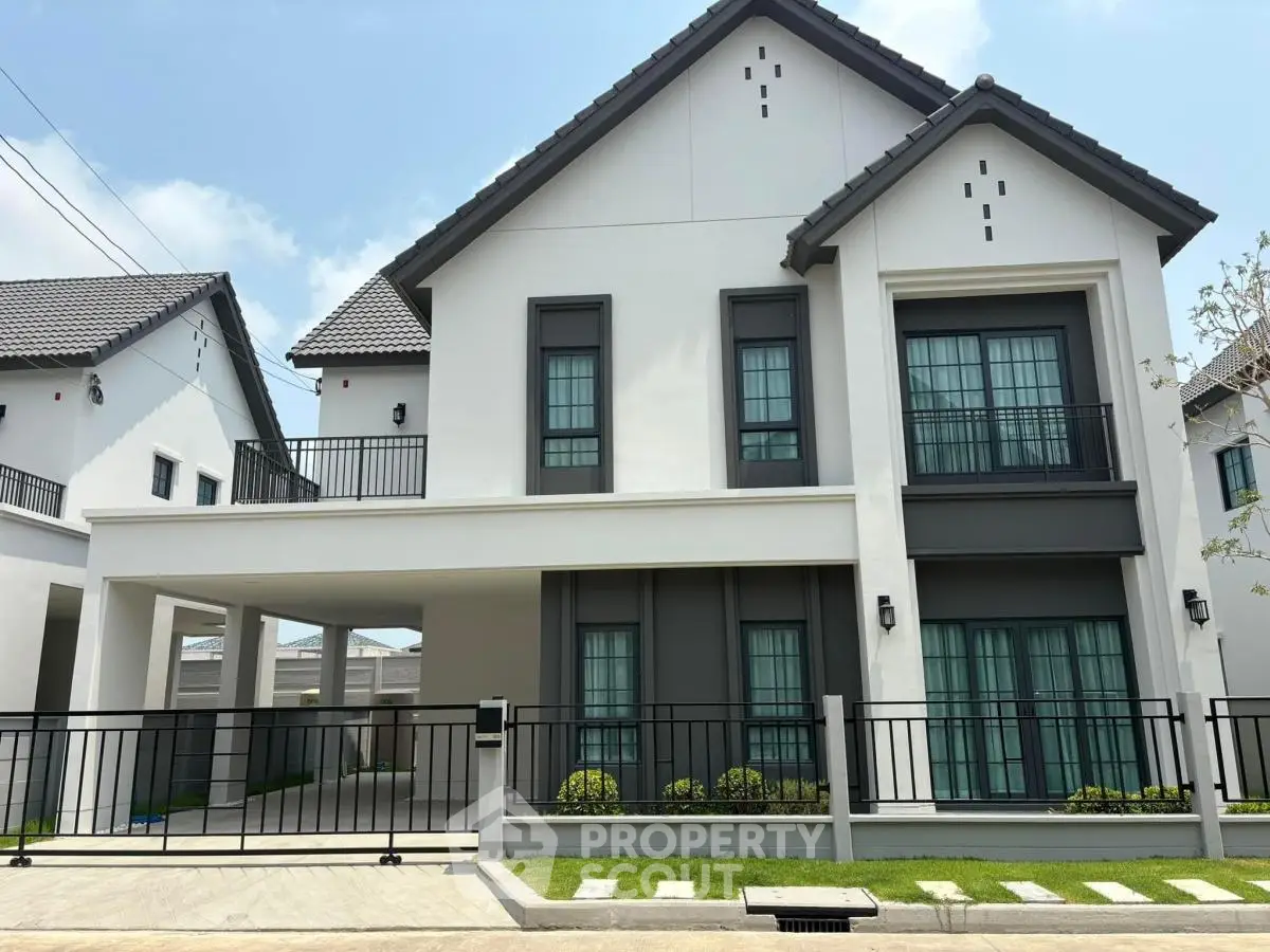 Modern two-story house with sleek design and spacious driveway in a serene neighborhood.