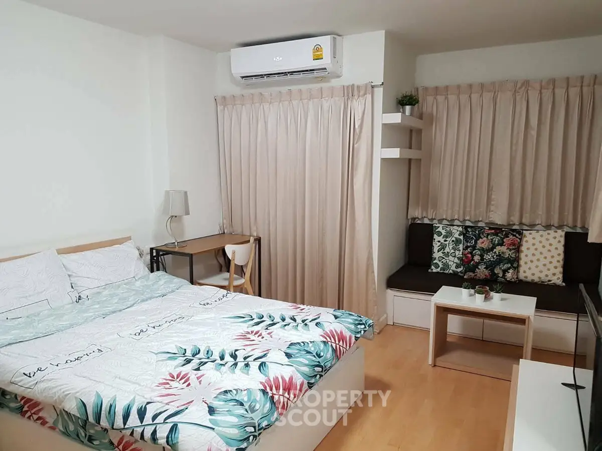 Cozy bedroom with modern decor and natural light, featuring a comfortable bed and stylish furnishings.