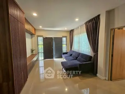 Spacious living room with modern decor and large windows for natural light.