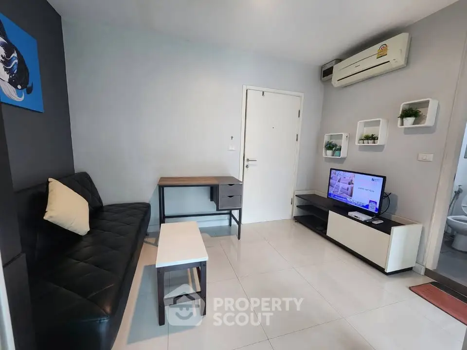 Modern living room with sleek furniture and wall-mounted TV, perfect for cozy urban living.