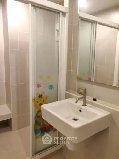 Modern bathroom with stylish sink and playful shower door design